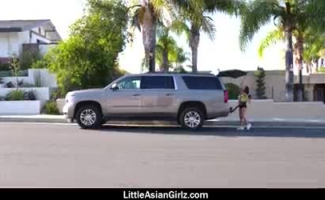 A Pequena Garota Asiática Está Sendo Comentada Em Uma Posição Em Estilo De Gangue, Em Frente à Câmera.